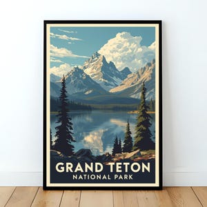 May include: A framed art print featuring a scenic view of Grand Teton National Park. The artwork depicts a mountain range reflected in a lake, with evergreen trees in the foreground. The text "GRAND TETON NATIONAL PARK" is displayed at the bottom.