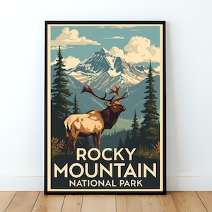 May include: A framed poster featuring a vintage-style illustration of an elk in a mountain landscape. The elk is brown and tan with large antlers. The background includes mountains, trees, and the text "ROCKY MOUNTAIN NATIONAL PARK". The color palette includes shades of green, blue, and brown.