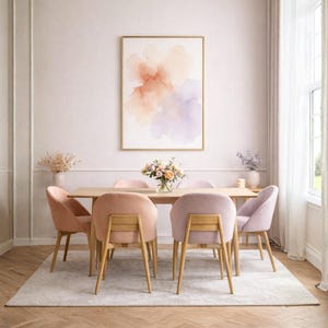 May include: A dining room scene featuring a light wood table surrounded by six velvet chairs in shades of pink and lavender. A framed abstract watercolor painting hangs on the wall. The room is decorated with flowers and a neutral rug.
