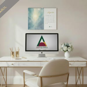 May include: A contemporary office scene with a white marble desk and gold detailing. A computer screen shows the "ARTQUIMIA" logo, and a calendar hangs above. A white chair and a vase of flowers are also present. The word "Español" is visible.