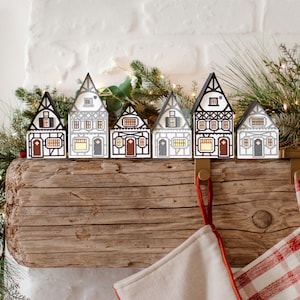 Half-Timbered Christmas Village: handmade layered-paper luminaries, folds flat to store