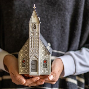 Christmas village church luminary: handcrafted of intricate layers of heavyweight watercolor paper, and it folds nearly flat for storage