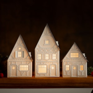 Lighted Christmas Village: holiday decorations handcrafted of layered paper, folds flat to store Gray timber