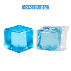 May include: Two blue, cube-shaped objects. One is loose, and the other is encased in clear plastic. The objects are a vibrant, transparent blue. The text "NO.FC-365 【蓝色】" is in a blue rectangle above the objects.