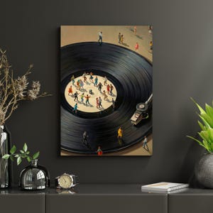 May include: A framed artwork depicts a black vinyl record with miniature figures dancing on its surface. The record player's needle is in place, and the figures are dressed in various colors. The background is a neutral beige.