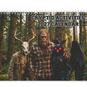 May include: A 2027 wall calendar titled CRYPTID ACTIVITIES. The cover features a forest scene with three figures: a person wearing a deer skull mask, a large hairy creature in a plaid shirt, and a dark winged creature with glowing red eyes.