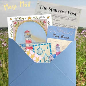 May include: A blue envelope containing stationery with lighthouse and star illustrations. The envelope is labeled "Mays Mail" and includes a newspaper clipping titled "The Sparrow Post" and a "May Bingo" card. The background is a field of purple flowers.