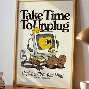 May include: A framed poster with the text "Take Time To Unplug" and a cartoon computer character. The poster is on a wooden desk with a lamp, books, and a mug. A plant sits in front of a window.