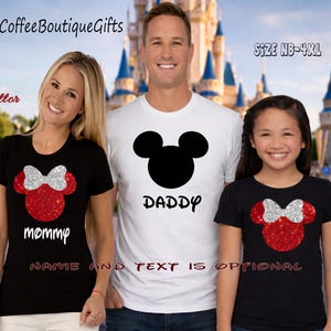 May include: Three people wearing matching t-shirts. The shirts feature a Mickey Mouse head design with the words "Mommy" and "Daddy" printed on them. The shirts are black and white with red and silver glitter accents. The text "NAME AND TEXT IS OPTIONAL" is also visible.