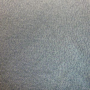 May include: Close-up of a textured, light blue fabric with a repeating pattern. The fabric has a subtle, woven appearance, with a mix of light and dark blue threads creating a visual depth. The overall texture appears soft and durable.