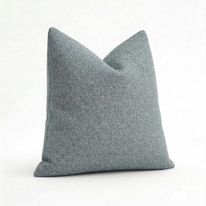 May include: A white ceramic mug with a black handle and the text "But First, Coffee" in a black, bold font. The mug is on a white surface. The mug is approximately 4 inches tall.