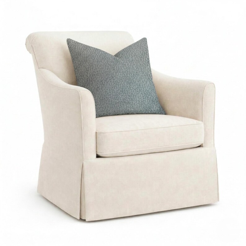 May include: A white ceramic mug with a black handle and the text "But First, Coffee" in a bold, black font. The mug is set against a blurred background, suggesting a cozy setting.