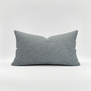 May include: A rustic wooden sign with the text "Welcome" in a handwritten style. The sign is painted white with a distressed finish, and features a decorative floral element in the corner. The background is a blurred image of a wooden surface.