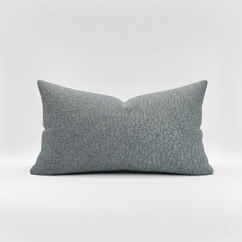 May include: A rustic wooden sign with the text "Welcome" in a handwritten style. The sign is painted white with a distressed finish, and features a decorative floral element in the corner. The background is a blurred image of a wooden surface.