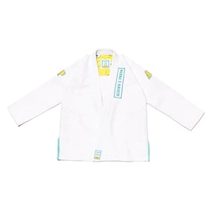 May include: White martial arts uniform with long sleeves, featuring light blue accents on the cuffs and a vertical text panel. The uniform has yellow patches and a yellow interior lining. The text "ALBINO E PRETO" is visible on the uniform.