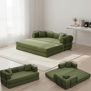 May include: Modular green sofa set with black metal armrests and pillows. The set is arranged in multiple configurations, including a large bed-like structure, a small sofa, and a single-person lounge. The furniture is placed on a light-colored rug.