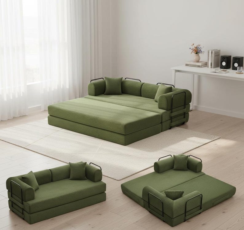 May include: Modular green sofa set with black metal armrests and pillows. The set is arranged in multiple configurations, including a large bed-like structure, a small sofa, and a single-person lounge. The furniture is placed on a light-colored rug.