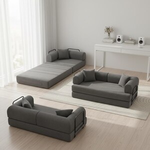 May include: Three modular gray fabric sofas with black metal frames and matching pillows. One sofa is fully extended, another is folded into a loveseat, and the third is a single seat. The sofas are on a light wood floor.