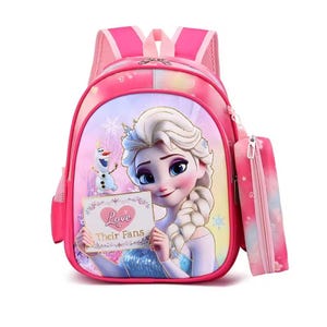 May include: Pink backpack featuring a cartoon image of a princess holding a sign that says "Love Their Fans". The backpack has a matching pencil case attached. The backpack has pink straps and a pink mesh back.
