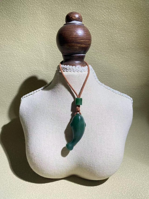 A green-certified jade fish-shaped pendant necklace from Canada, with a woven string, as a gift for him.