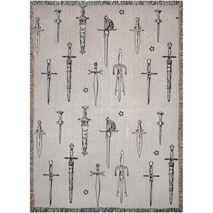 May include: A woven throw blanket with a repeating pattern of black swords on a light gray background.