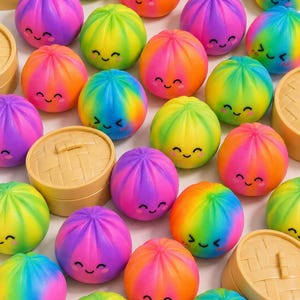 May include: A collection of colorful, smiling dumpling-shaped toys in a variety of rainbow hues. The toys have a pleated design and are arranged with small, tan-colored steamer baskets. The toys are a vibrant mix of pink, orange, yellow, green, blue, and purple.