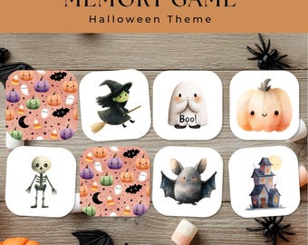 May include: A Halloween-themed memory game with illustrated cards featuring pumpkins, ghosts, bats, a witch, and a haunted house. The cards are arranged on a wooden surface, with the words "MEMORY GAME" and "Halloween Theme" at the top.