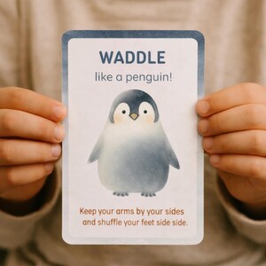 以下が含まれることがあります： ペンギンの水彩イラストが描かれた長方形のカード。カードには「WADDLE like a penguin!」と「Keep your arms by your sides and shuffle your feet side side.」というテキストが書かれています。