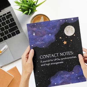 May include: A journal titled "CONTACT NOTES" held by hands, featuring a night sky design with a full moon and stars. The journal's cover has a dark background with the text "A journal for UFOs; synchronicities, and high strangeness."