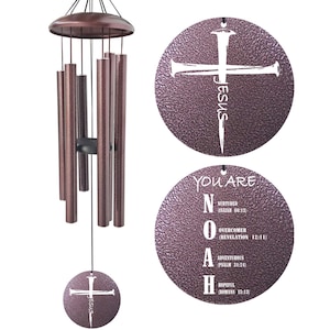 May include: Bronze-colored wind chimes with a cross design and the word "JESUS" on the top disc. The bottom disc has the word "NOAH" with the words "Nurtured", "Overcomer", "Adventurous", and "Hopeful".