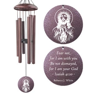 May include: Bronze-colored wind chimes with a circular pendant featuring a white image of Jesus and the text "Fear not, for I am with you...Isaiah 41:10." The chimes have multiple tubes and a top dome.