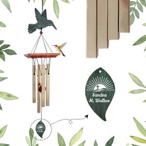 May include: Hummingbird wind chimes with a teal-colored hummingbird figure at the top. The chimes have a wooden base and gold-colored tubes. A small, colorful hummingbird is perched on the wooden base. The tag reads "Sandra M. Walker".