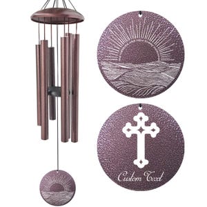 May include: Bronze-colored wind chimes with a circular pendant featuring a sunrise design and the text "The Blessings Are New Every Morning." Another pendant displays a cross and the words "Custom Text."