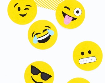 May include: Six yellow circle stickers with different emoji faces. The emojis include a winking face, a tongue sticking out face, a crying laughing face, a face with sunglasses, a face with a frown and teeth, and a blushing face.