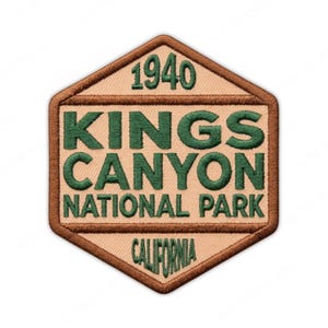 May include: A tan and brown embroidered patch with the text "KINGS CANYON NATIONAL PARK CALIFORNIA" in green lettering. The year "1940" is at the top. The patch has a hexagonal shape.