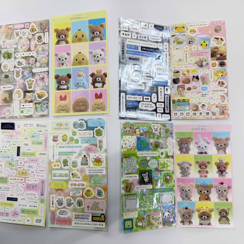 May include: Eight sheets of decorative stickers featuring various cartoon characters, including brown bears, white bears, and yellow chicks. The sheets display a mix of grid-style character portraits, small food items, speech bubbles, and Japanese text.