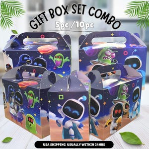 May include: A set of five dark blue gift boxes featuring space-themed graphics of robots and green creatures. The boxes have integrated handles and display the text GIFT BOX SET COMBO 5pc / 10pc at the top. The design includes planets and stars.