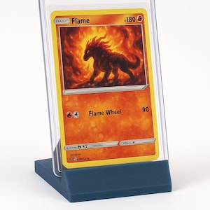 May include: A trading card featuring a fiery creature with the text "Flame Wheel" and "Flame" on a yellow background. The card is displayed in a clear plastic holder on a blue stand.