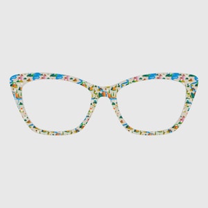 May include: Cat-eye style eyeglasses with a cream-colored frame featuring a colorful camping scene pattern. The pattern includes tents, trees, rivers, and mountains. The glasses have clear lenses and a modern design.