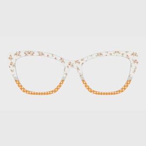 May include: Cat-eye glasses frames featuring a white base with a delicate orange and yellow floral pattern on the upper rims and a vibrant orange and white gingham checkered pattern along the lower rims, separated by a thin white lace-like trim.