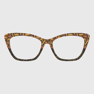 May include: Cat-eye eyeglasses with a unique bread-themed pattern. The frames feature various bread illustrations in shades of brown and tan against a dark background. The lower rims are accented with gold glitter.