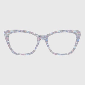 May include: Cat-eye glasses featuring a translucent frame with an embedded pattern of iridescent, multi-coloured sequins and glitter in shades of blue, pink, and silver. The frame has a distinct upswept shape at the outer corners and clear lenses.