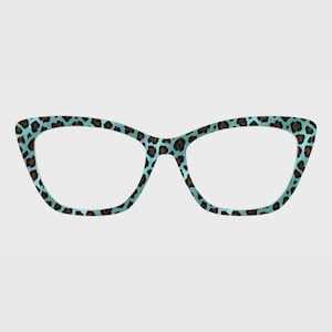 May include: Cat-eye spectacles with a teal and brown leopard print pattern. The frames have a light blue background with dark brown spots. The lenses are clear. The glasses are a fashionable accessory.