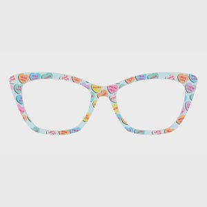 May include: Cat-eye glasses frames featuring a light blue base color and a repeating pattern of pastel-colored heart-shaped candies. Each candy includes printed text such as TRUE LOVE, MISS YOU, HUGS, HAPPY, THANK YOU, and I LOVE YOU.