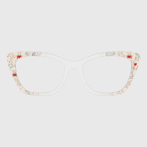 May include: Cat-eye eyeglasses with a cream-colored frame. The frame is decorated with a pattern of small teddy bears and red hearts. The lenses are clear.