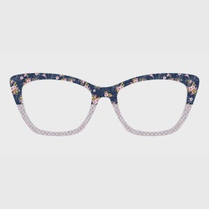 May include: Cat-eye glasses featuring a dark blue upper frame with a pink and white floral pattern. The lower portion of the frame displays a light grey and white checkered grid pattern. The design combines a bold floral print with a geometric grid.