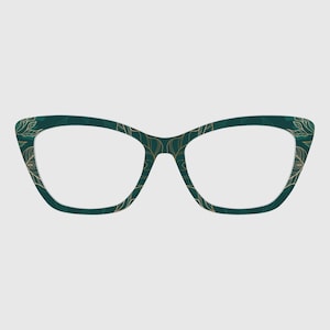 May include: Cat-eye spectacles with a dark teal frame and a gold leaf pattern. The lenses are clear. The glasses have a classic, elegant design. The frame's colour and pattern create a sophisticated look. The frame is approximately 14 cm wide.