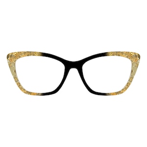 May include: Cat-eye eyeglasses with a black frame and gold-colored accents. The gold detailing features a textured pattern. The lenses are clear, and the glasses are set against a white background.
