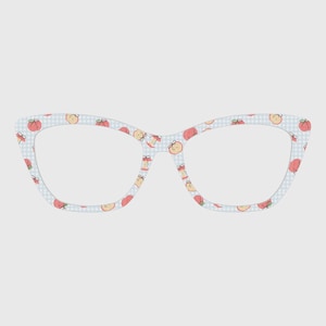 May include: Cat-eye style eyeglasses with a light blue and white checkered pattern. The frames are decorated with a repeating pattern of red and yellow fruit. The glasses have clear lenses.