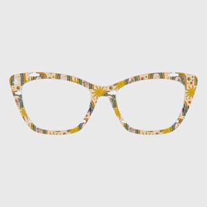 May include: Cat-eye style eyeglasses with a beige background and a colorful pattern of rainbows, suns, clouds, and peace signs. The frames have a retro, whimsical design.